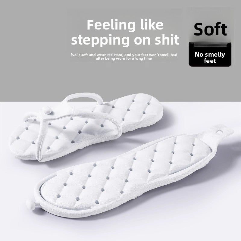 Pair of foldable EVA slippers folded in half at the arch to pack flat for travel