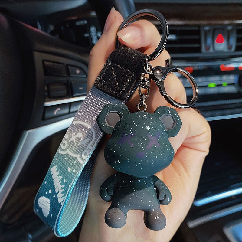 Color changing bear charm showing a deeper tone in different light in a car