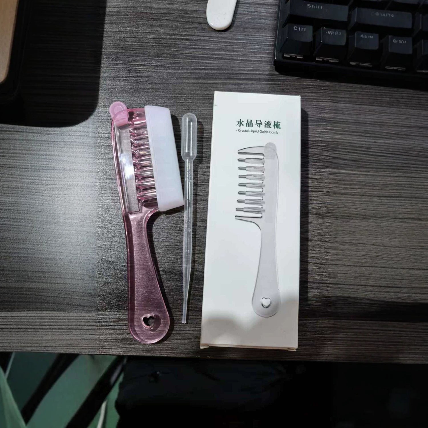 Liquid dispensing hair comb shown with the reservoir teeth that carry serum down to the scalp