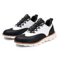 Pair of black and white wingtip brogue casual shoes with mesh tongue and orange welt on a white background