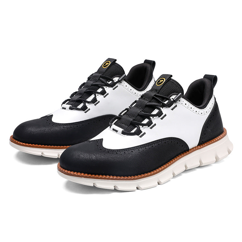 Pair of black and white wingtip brogue casual shoes with mesh tongue and orange welt on a white background