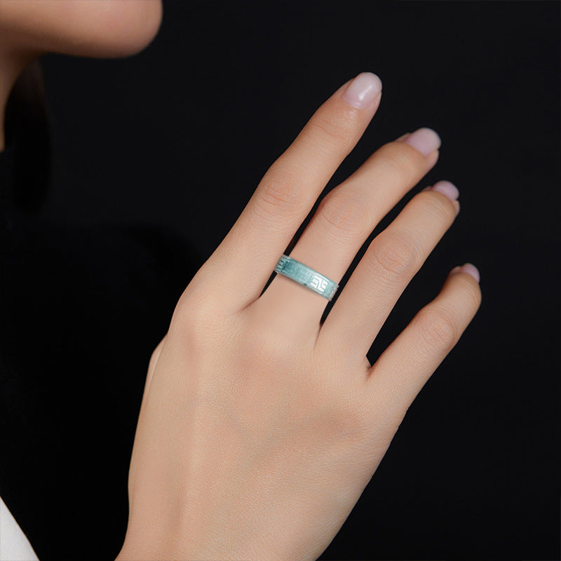 Blue water jadeite band ring showing the antique fret carving around the outside