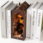 Magic Library wooden book nook with a lit Gothic scene standing between white books on a shelf