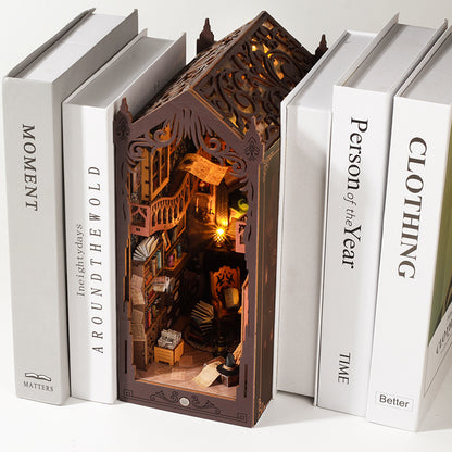 Magic Library wooden book nook with a lit Gothic scene standing between white books on a shelf