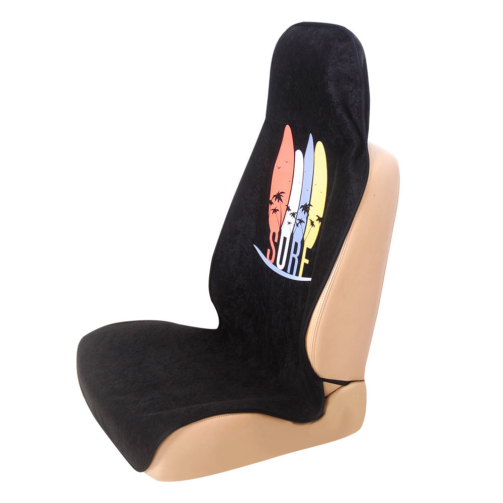 Black terry cloth seat cover with a surf print on a tan car seat, product view on a white background