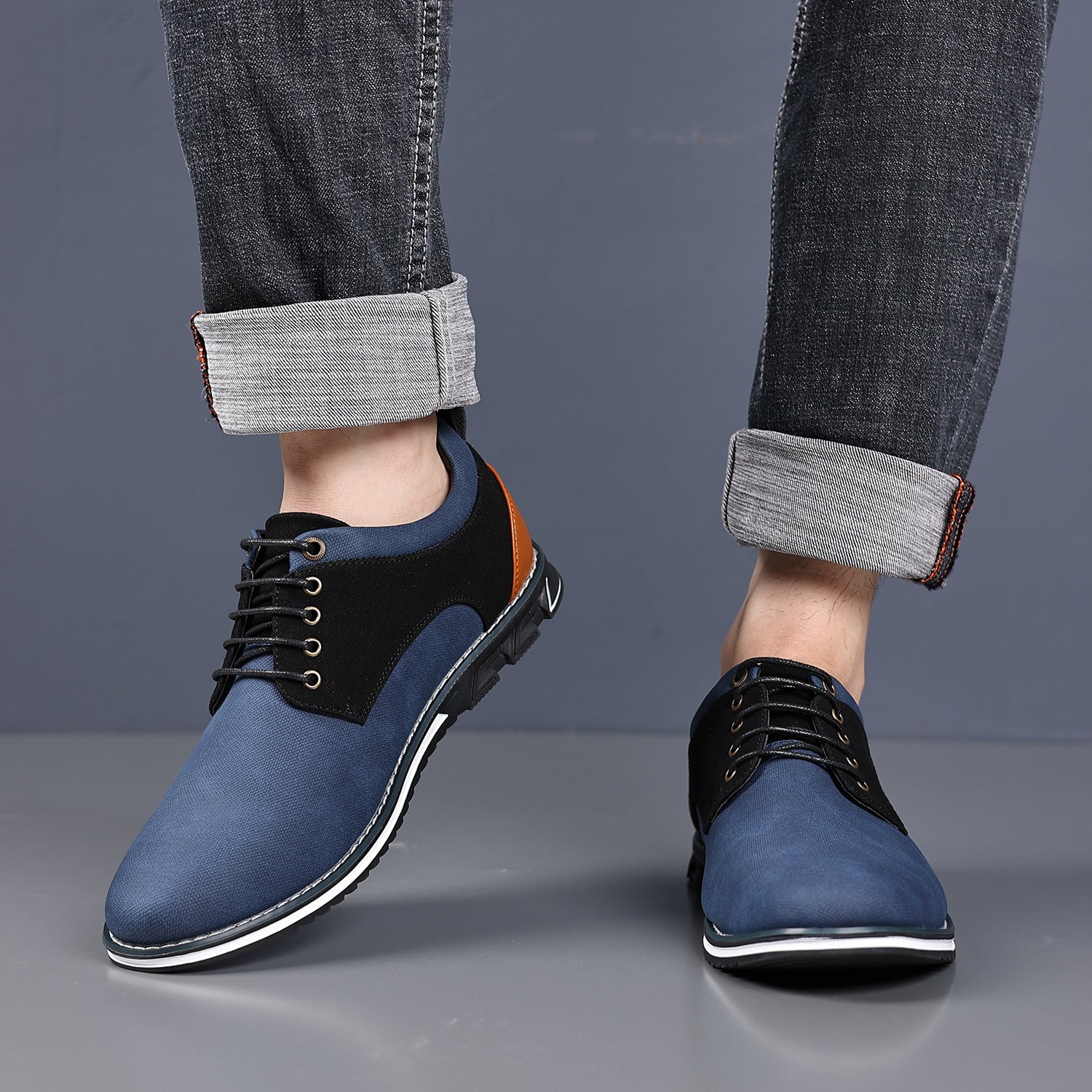 Side view of a mens derby shoe with contrast heel panel and treaded rubber sole