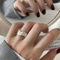 Open silver-tone ring shown at an angle on the hand to show the band gap
