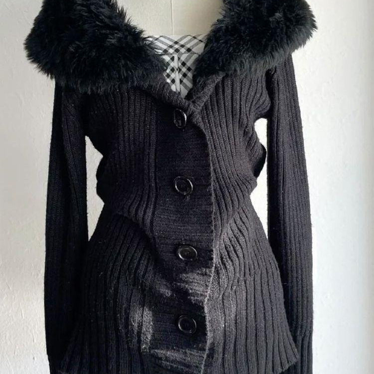 Close up of the plush collar and round black buttons on a black ribbed knit cardigan