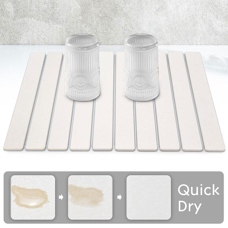 Foldable diatomaceous earth absorbent mat with a slatted design for bath and kitchen