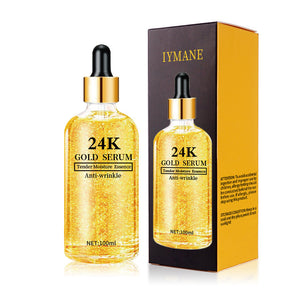 Two golden dropper bottles of the 24K gold hyaluronic acid face serum beside a gold gift box