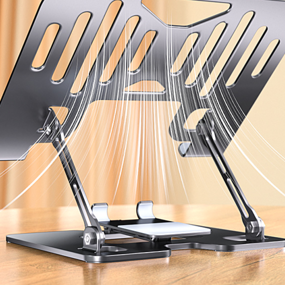 Underside view of a slotted laptop stand with two adjustable arms standing on a wooden desk