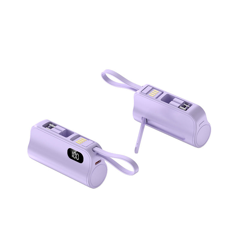 Two purple mini capsule power banks with digital displays and lanyard loops, one standing and one lying down