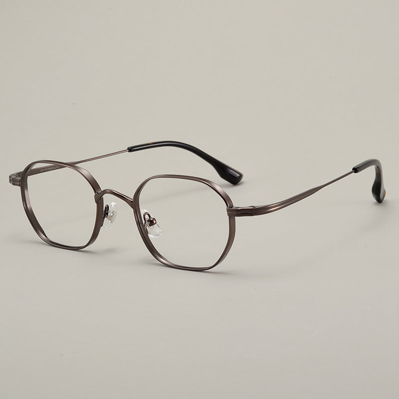 Top down view of the folded titanium eyeglasses frame on a plain surface