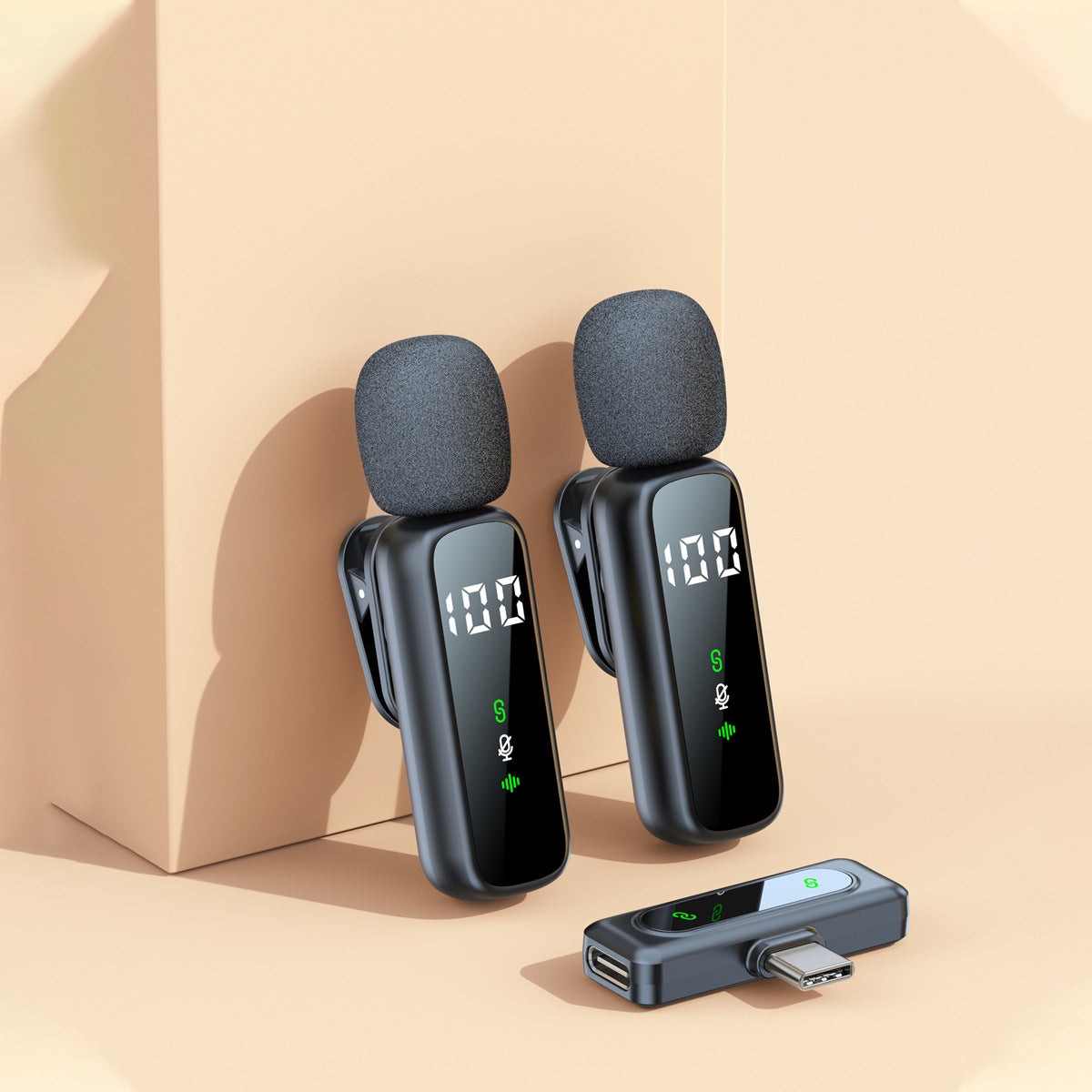 Two wireless lavalier clip mics with a USB-C receiver on a beige background