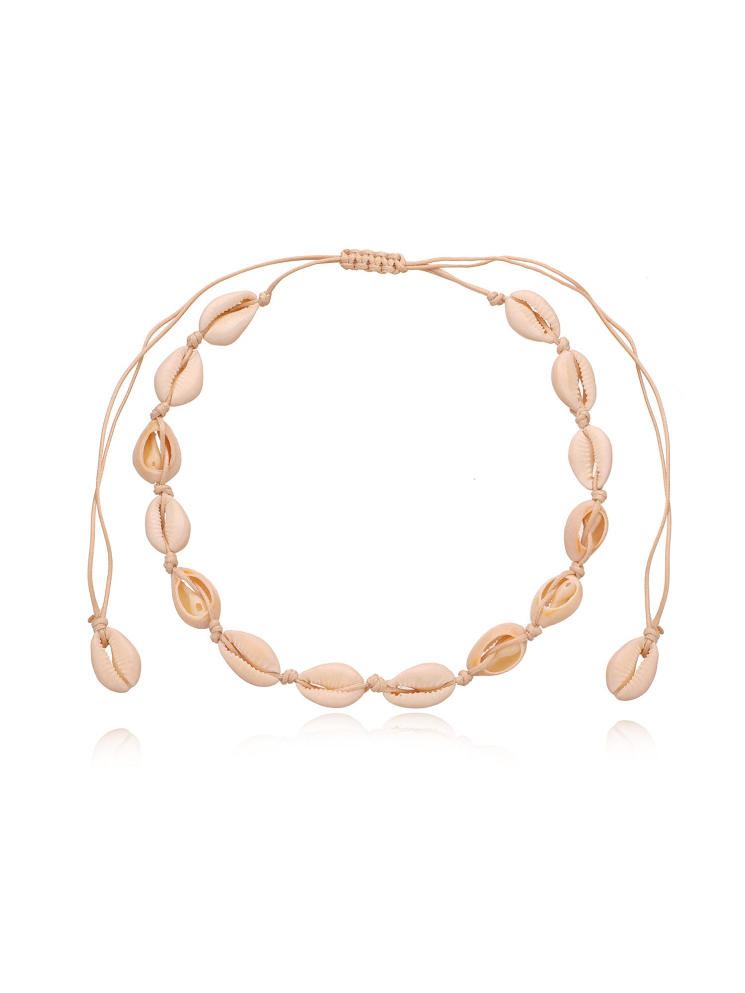 Overhead view of the cowrie shell choker on black cord with its macrame sliding knot at the top
