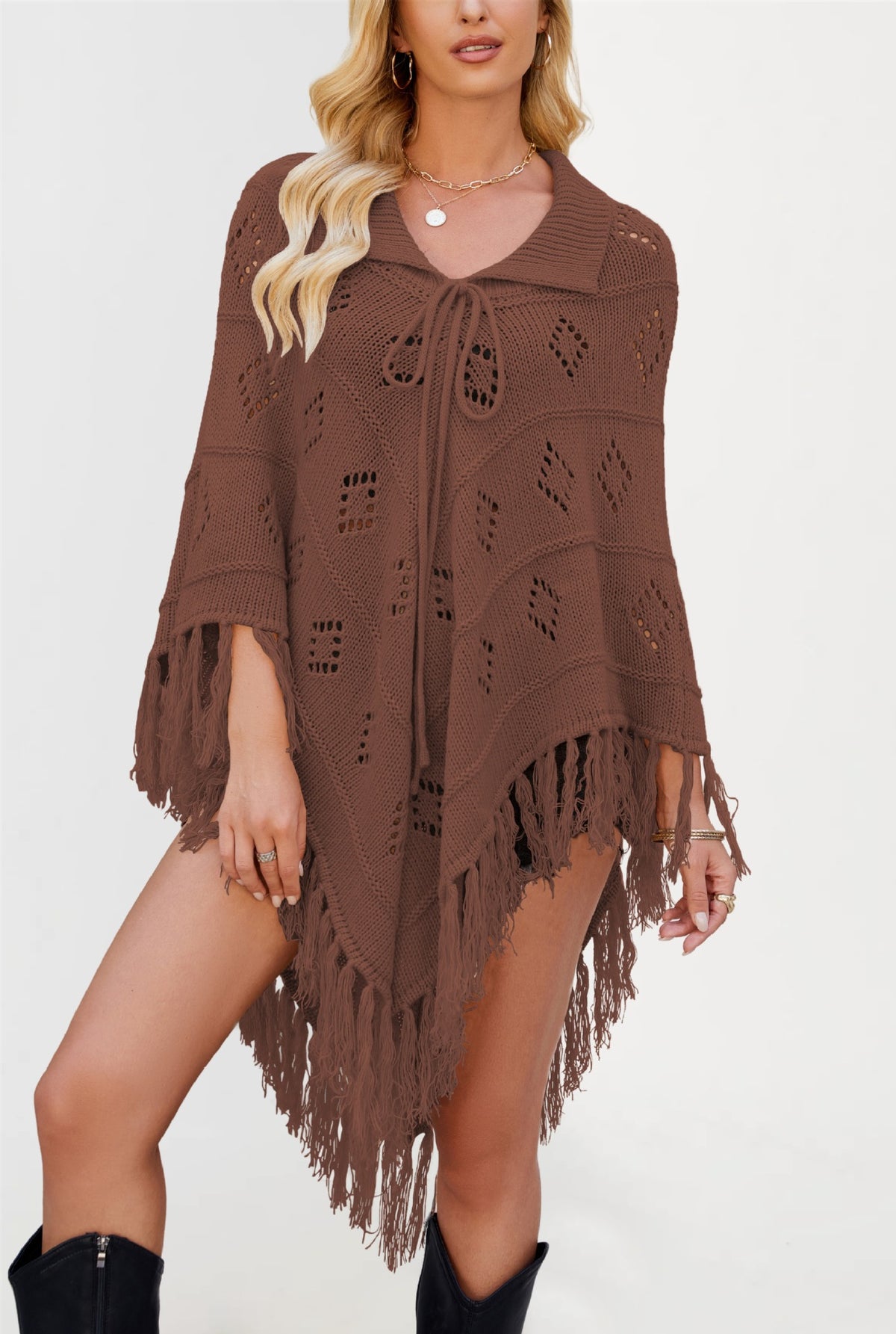 Draped acrylic knit poncho with front tie collar and pointed fringed hem on a model