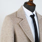 Herringbone wool overcoat styled with trousers in a neutral outfit