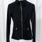 Outfit shot, running jacket paired with leggings and trainers on path