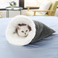 Gray waffle weave cat sleeping bag with plush white fleece lining and a cat resting inside on a bed