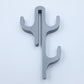 Gray resin three hook with three arms, seen from the front on a light background