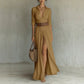 Woman in an amber long shirt dress with collar, brown belt and a high front slit, full length front view