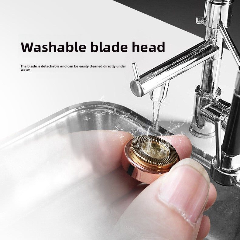 Round foil blade head of the ladies shaver rinsed clean under a running tap