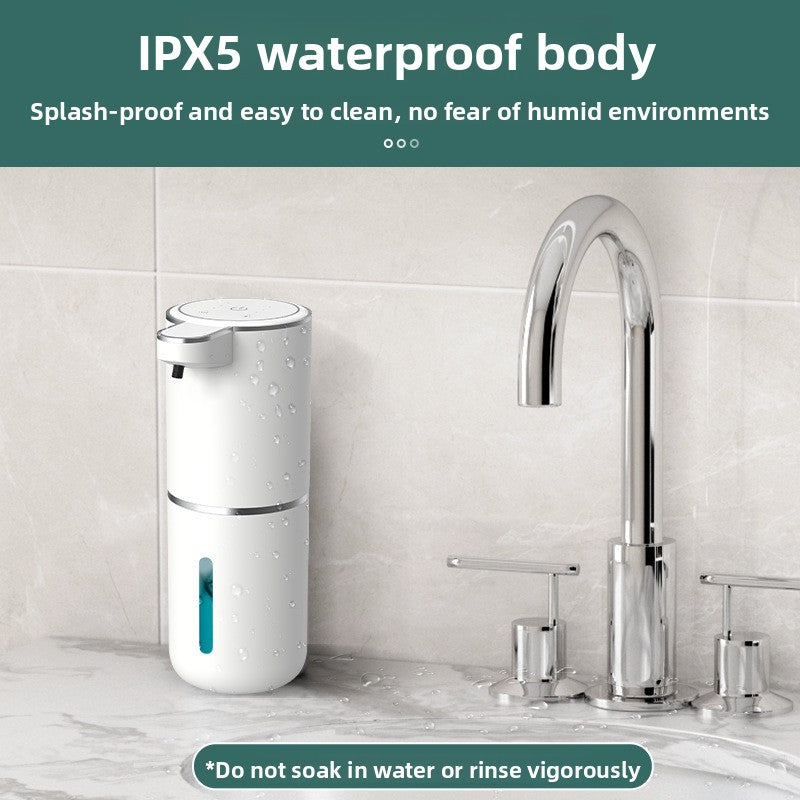 White automatic foaming soap dispenser on a marble counter beside a chrome faucet