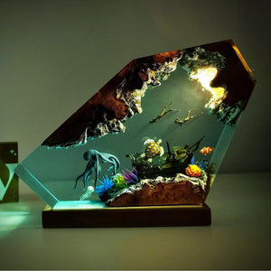 Ocean resin night light in warm amber light showing turtle, free divers and a shipwreck
