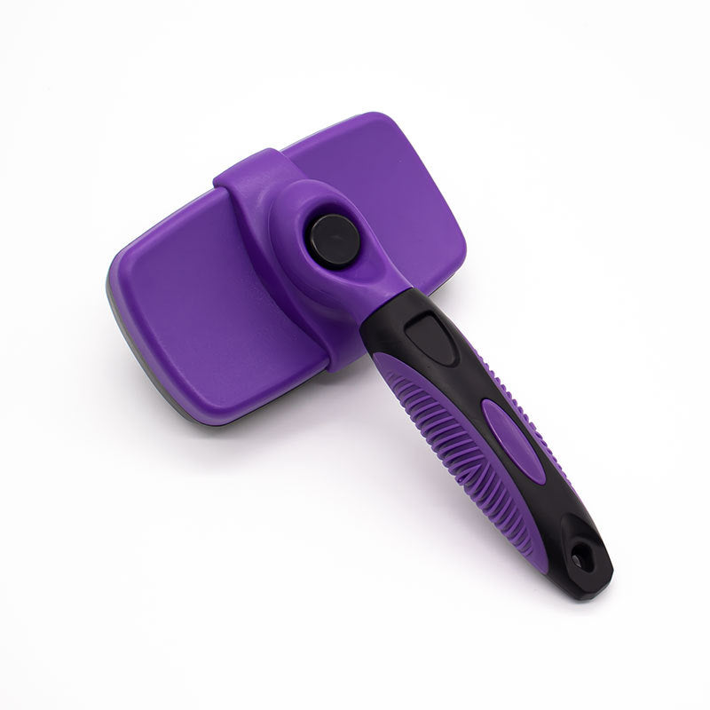 Purple ABS self cleaning pet slicker brush shown from the top with the retract button on the head