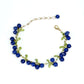 Purple bead clusters and green enamel leaves on a delicate gold tone link bracelet