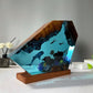 Ocean resin and wood night light showing divers and coral in clear blue resin