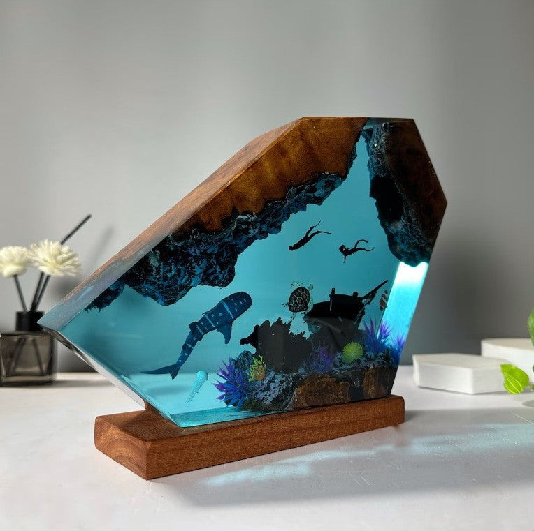 Ocean resin and wood night light showing divers and coral in clear blue resin