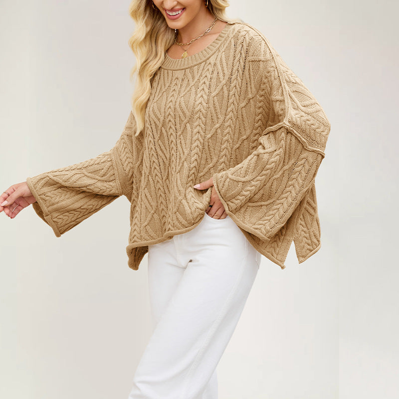 Cable knit pullover with wide flared sleeves and a short side slit at the boxy hem
