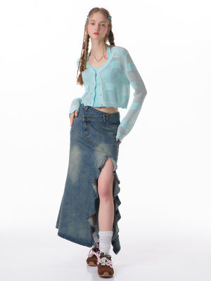 Side view of the fishtail hem flaring just below the knee on a sunlit pavement
