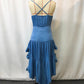 Back view of the royal blue dress on a form, slim straps crossed at the back above a gathered elastic band