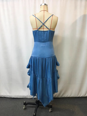 Back view of the royal blue dress on a form, slim straps crossed at the back above a gathered elastic band