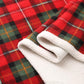 Red tartan coral fleece blanket folded to show the cream pile reverse and bound edge