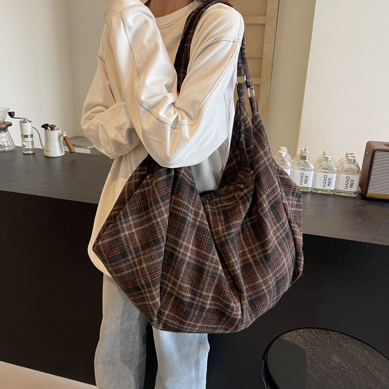 Interior of the woolen plaid tote showing the polyester cotton lining and inner phone pocket