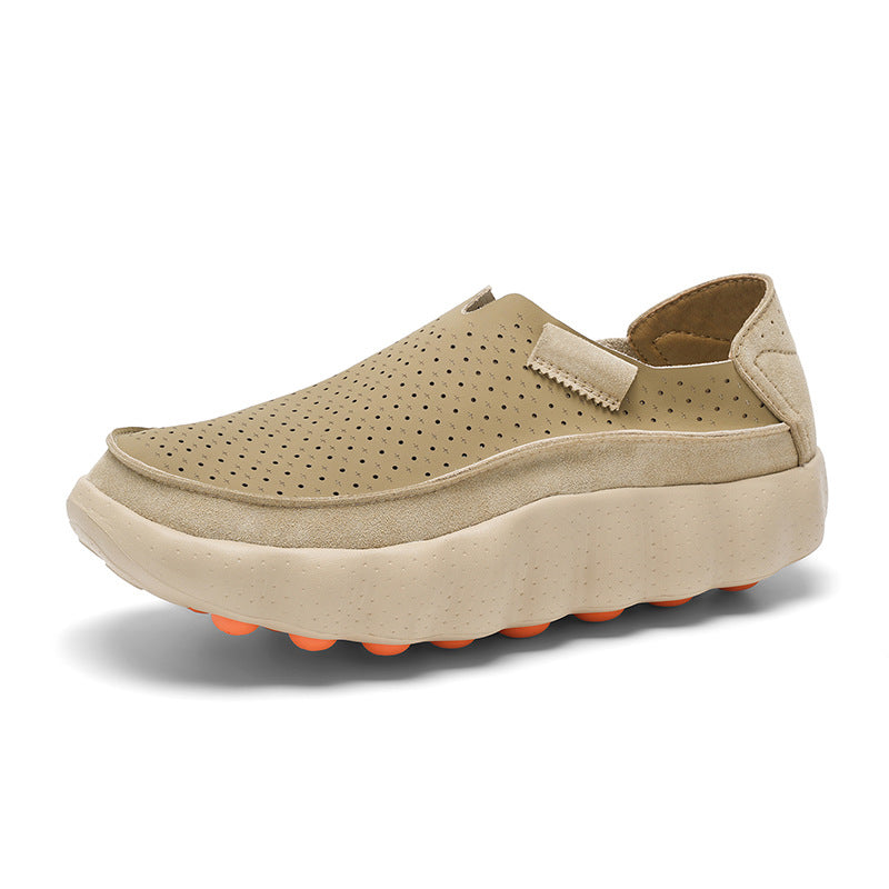 Khaki perforated leather slip-on platform shoe with cream wavy sole and orange studs, three quarter view