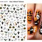 Halloween nail decals shown as a finished manicure with skulls and pumpkins