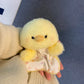 Yellow plush chick squishy bean bag toy in hand, fluffy body and a starry cotton apron