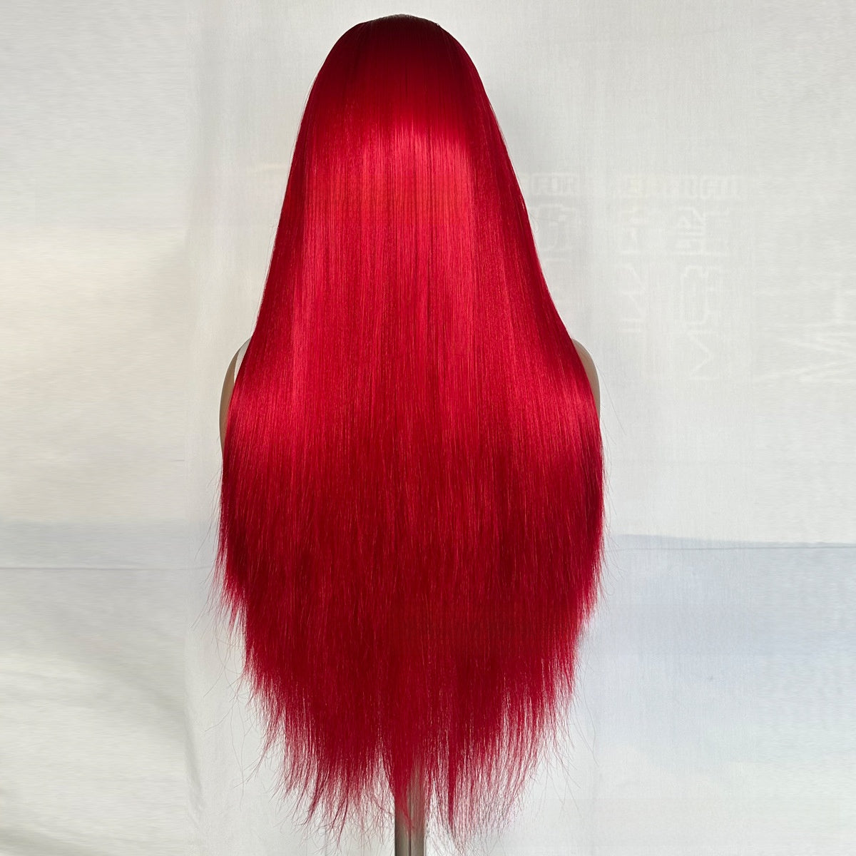 Back view of a long straight Neptune red synthetic wig hanging straight to the tips