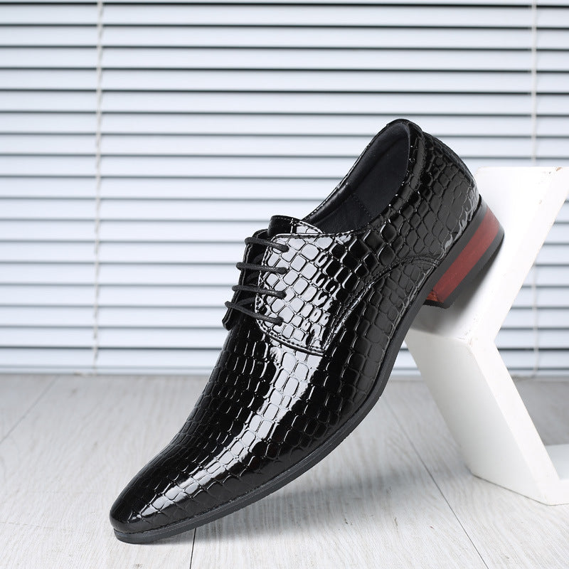 Black croc embossed PU derby shoe with pointed toe and low heel, on a white block, striped wall, EU 44 option