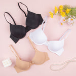 Push-up molded cup bra shown in black, white and nude in a flat lay with the 3/4 cups visible