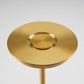 Top view of the gold lamp shade, a flat brushed disc with a raised round pad at its center