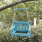 Blue wooden bench shaped bird feeder with a slatted backrest hanging from rope under a tree branch