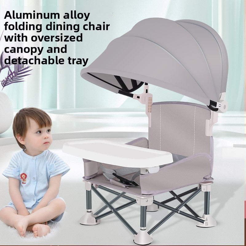 Folding baby feeding chair with canopy and tray seen from the front on a plain floor