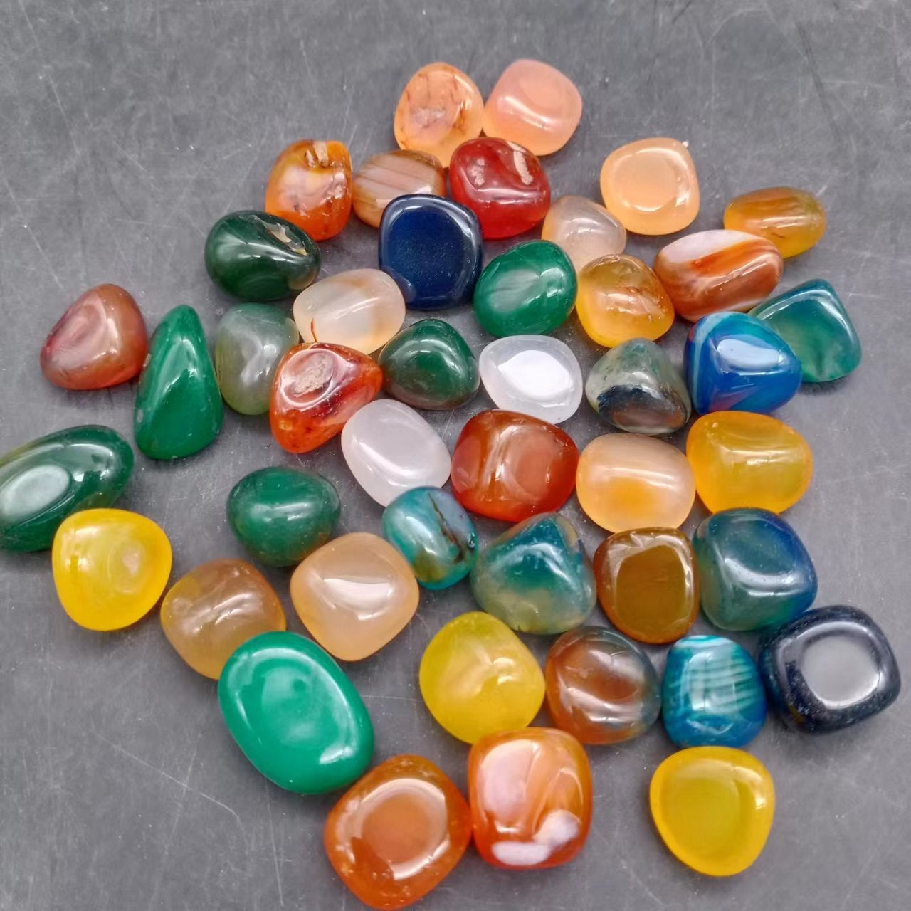 Loose decorative stone lot of glossy agate pebbles in several colours