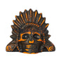 Black ceramic skull death whistle with orange painted feather headdress and eye sockets on a white background