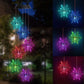 Snowflake LED figures glowing in several colors, hanging from a solar lamp head, black housing option